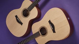 A pair of Taylor Guitars Academy Series acoustic guitars on a purple background