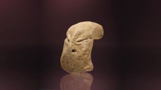 a clay figurine of a head