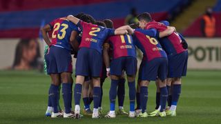 FC Barcelona players huddle in a circle before a La Liga match