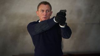 Daniel Craig as James Bond holding a gun