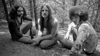 Grand Funk Railroad sitting in woodland