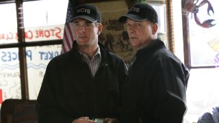 Michael Weatherly and Mark Harmon wearing their NCIS caps and jackets inside a restaurant