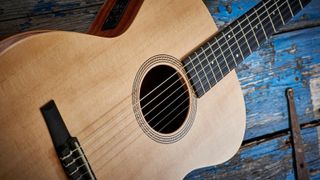 Taylor classical guitar with blue wooden background