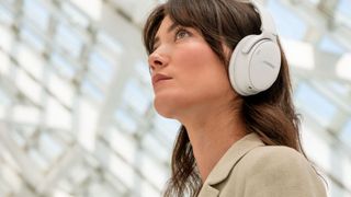 Person wearing Bose QuietComfort headphones