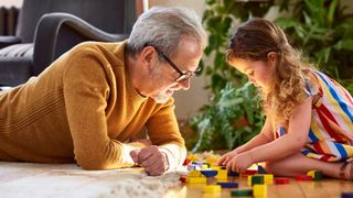 Adult and child playing with toys. 10&#039;000 Hours via Getty Images