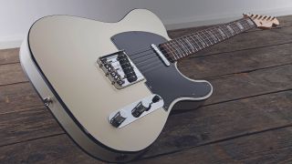 A Telecaster guitar lying on a wooden floor