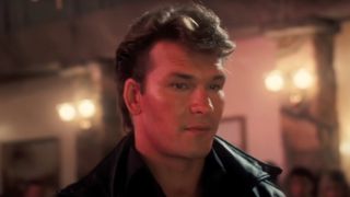 Patrick Swayze standing in the ballroom in Dirty Dancing.