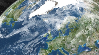 True colour satellite image of the Earth showing Greenland, Europe and Northern Africa, with cloud coverage.