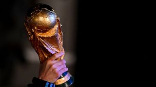 TOPSHOT - Argentina&#039;s captain and forward Lionel Messi holds the FIFA World Cup Trophy upon arrival at Ezeiza International Airport after winning the Qatar 2022 World Cup tournament in Ezeiza, Buenos Aires province, Argentina on December 20, 2022. (Photo by Luis ROBAYO / AFP) (Photo by LUIS ROBAYO/AFP via Getty Images)