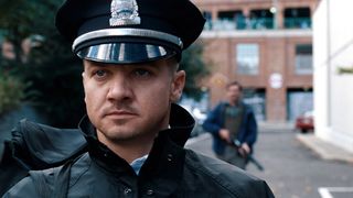 Jeremy Renner dressed as a police officer in The Town