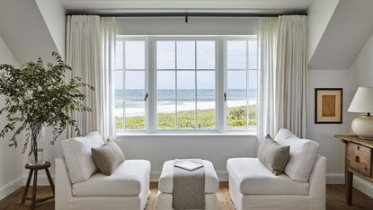 White living room with large window and white curtains