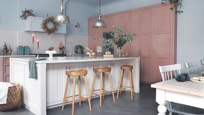 Pink kitchen with white island and Christmas decorations