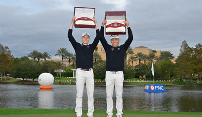 Jason and Bernhard Langer hold the PNC Championship belts above their heads