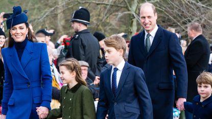 Kate Middleton, Princess Charlotte, Prince William, Prince George, Prince Louis holding hands wearing blue coats and walking to church