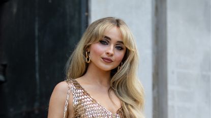 Sabrina Carpenter is seen wearing golden dress outside Paco Rabanne during Paris Fashion Week on July 03, 2022 in Paris, France