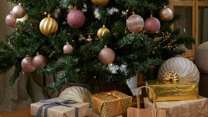 A Christmas tree decorated with metallic baubles in a living room