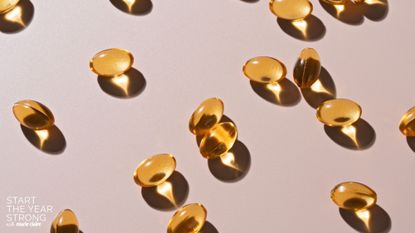 A flat lay of supplements on a pink background