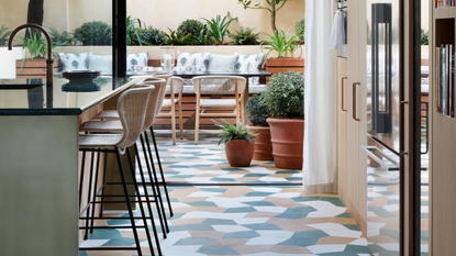 Orange and blue tiles in irregular pattern on kitchen floor