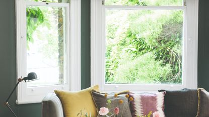 A living room with a large window and a sofa