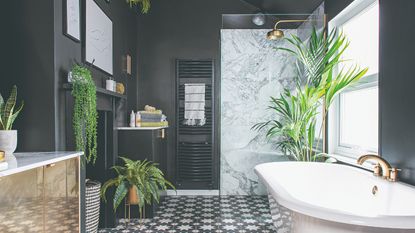 Bold black contemporary bathroom, with large walk-in shower and freestanding bath and green plants