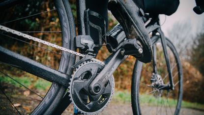 Male cyclist clipped into a power meter pedal