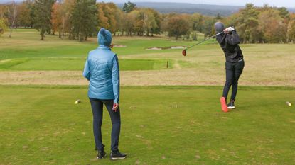 Male and female golfer playing golf in the winter