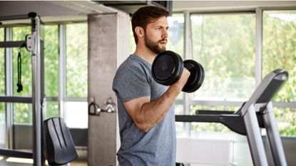 A man performing bicep curls during dumbbell workout