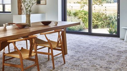 dining room with mid century modern table and chairs, carpet, crittall doors to outside, Brintons