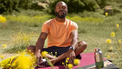 best smartwatch: person meditating outdoors wearing the Google Pixel Watch 2