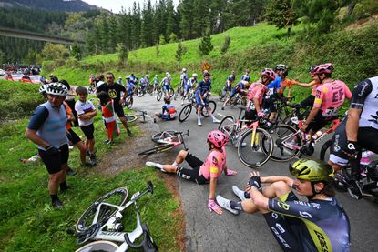 Riders sit on the ground after the serious crash at Itzulia Basque Country in April