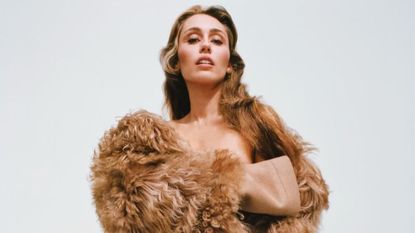 Miley Cyrus wearing a shaggy winter coat in a photo shoot