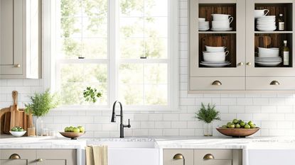 A window over a kitchen farmhouse sink, green trees seen outside 