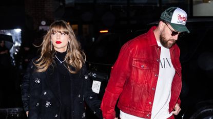 Taylor Swift in a long, crystal-embellished black coat and Travis Kelce, wearing red pants and a matching red jacket, while out in New York City on December 28, 2024