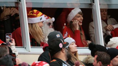 Taylor Swift wearing a Santa hat while in the stadium at a Kansas City Chiefs Game on Christmas Day in 2023.