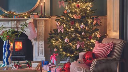 Christmas living room decori deas with striped chair and bows.