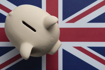 Piggy bank on Union Jack flag, signifying NS&amp;I&#039;s British Savings Bonds