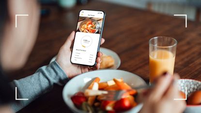 Woman using a calorie counter app to stay in a calorie deficit to lose weight
