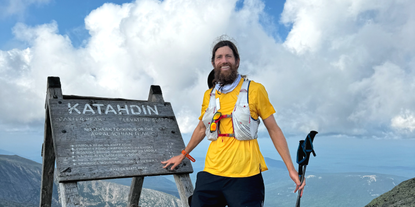 Ultramarathon runner Michael Wardian poses at the top of Mount Katahdin on the Appalachian Trail.