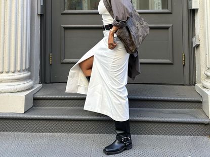 Biker flat boots with circular buckle detail on ankle and white dress.