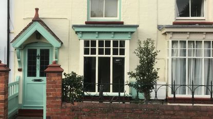 Light blue and yellow exterior of Victorian mid-terrace