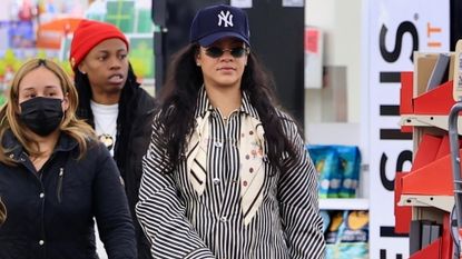 Rihanna shops at CVS wearing a striped pajama suit and glazed french tips