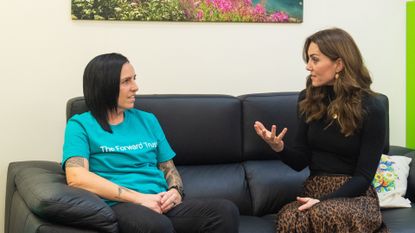 Kate Middleton wears a black top, a brown skirt, and black heeled boots to meet a prisoner