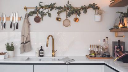 White modern kitchen with christmas garland on wall