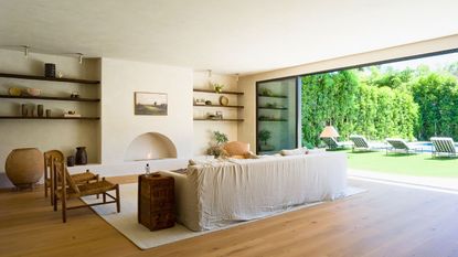 LA living room white sofa glass wall to garden