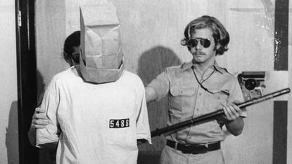 Prisoner with guard John Loftus, involved in the Stanford Prison Experiment