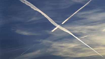 Contrails cross the sky