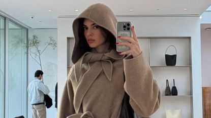 Kendall Jenner in a tan scarf coat by The Row in a picture she shared on her Instagram Story.