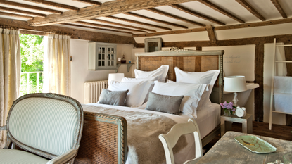 rustic farmhouse bedroom with four Oxford pillowcases on the bed.