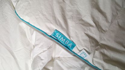 A close up of the Simba Hybrid Duvet showing its blue branded label