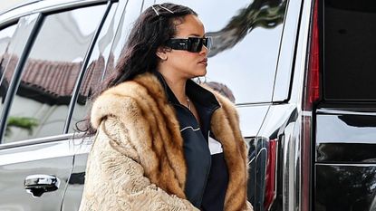 Rihanna in a massive fur coat and designer pearl crocs while out shopping in Beverly Hills with A$AP Rocky on December 14, 2024.